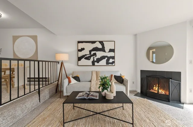 a living room with furniture a rug and a fireplace