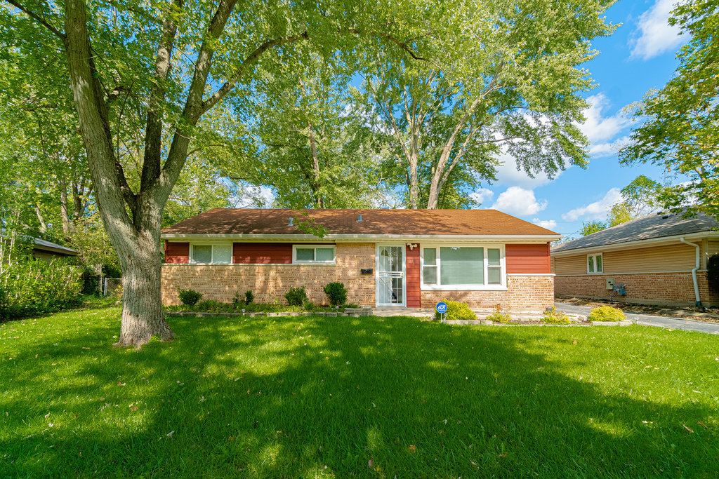 172 Monee Road Park Forest, IL 60466 - Photo 1 of 16 a front view of house with yard and green space
