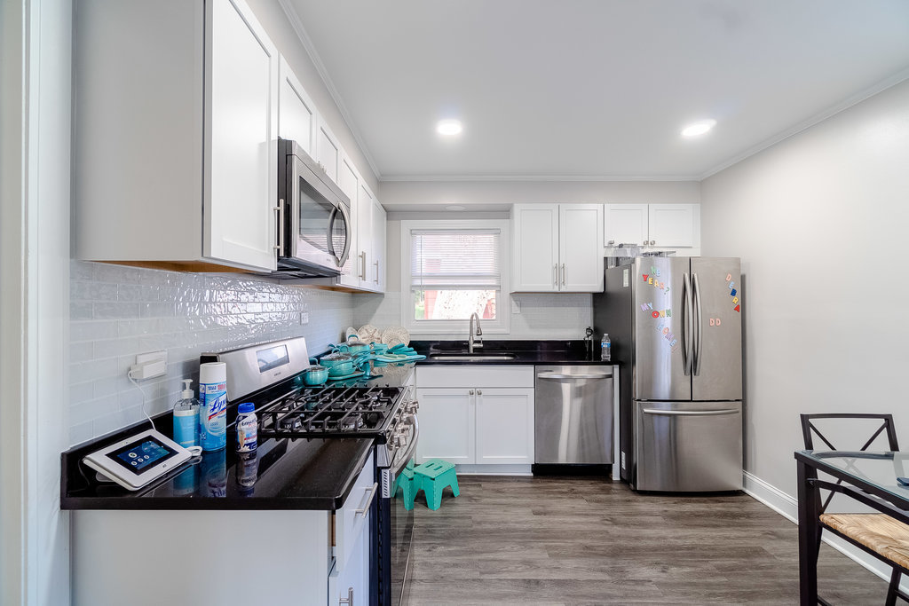 172 Monee Road Park Forest, IL 60466 - Photo 5 of 16 a kitchen with kitchen island granite countertop a stove and a refrigerator