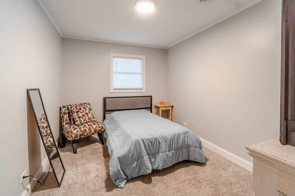 172 Monee Road Park Forest, IL 60466 - Photo 6 of 16 a bedroom with a bed chair and a window