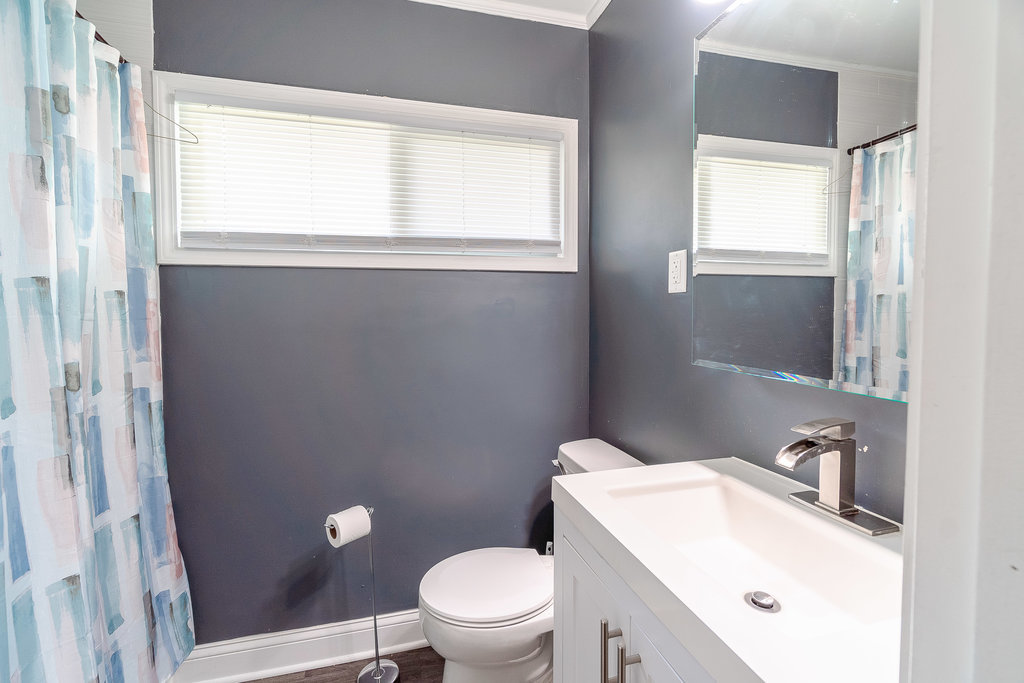 172 Monee Road Park Forest, IL 60466 - Photo 7 of 16 a white toilet sitting next to a bathroom sink