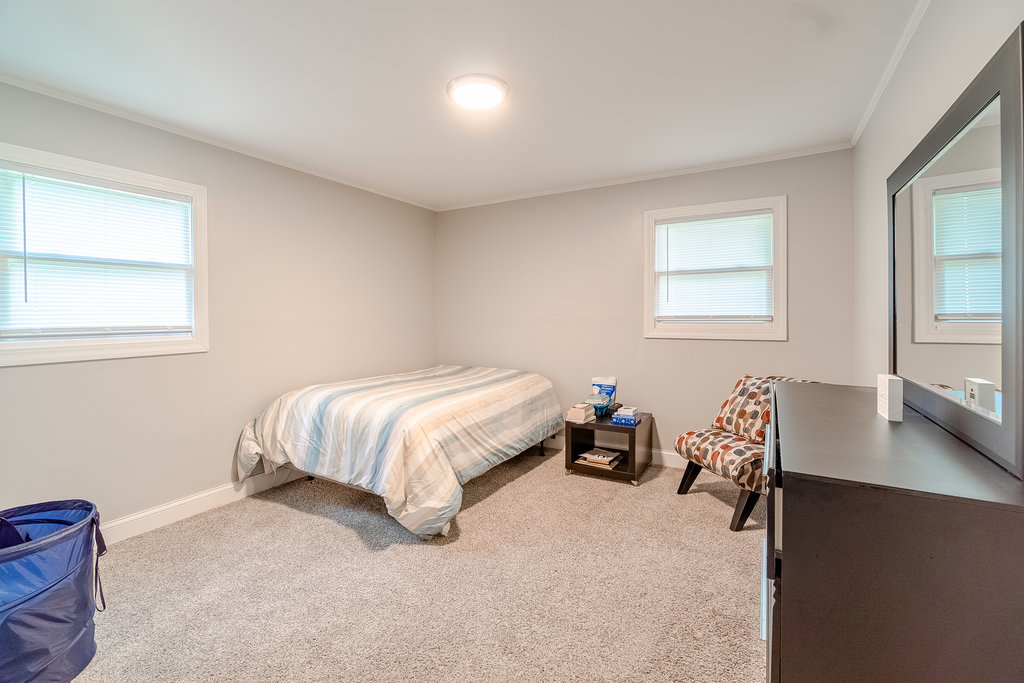 172 Monee Road Park Forest, IL 60466 - Photo 8 of 16 a bed sitting in a bedroom next to a window
