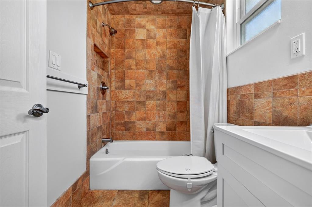 1309 Suwanee Road Daytona Beach, FL 32114 - Photo 18 of 33 a bathroom with a toilet and a shower