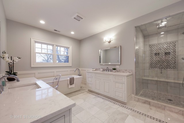 117 Church Road Winnetka, IL 60093 - Photo 4 of 29 a large bathroom with a tub sink and mirror
