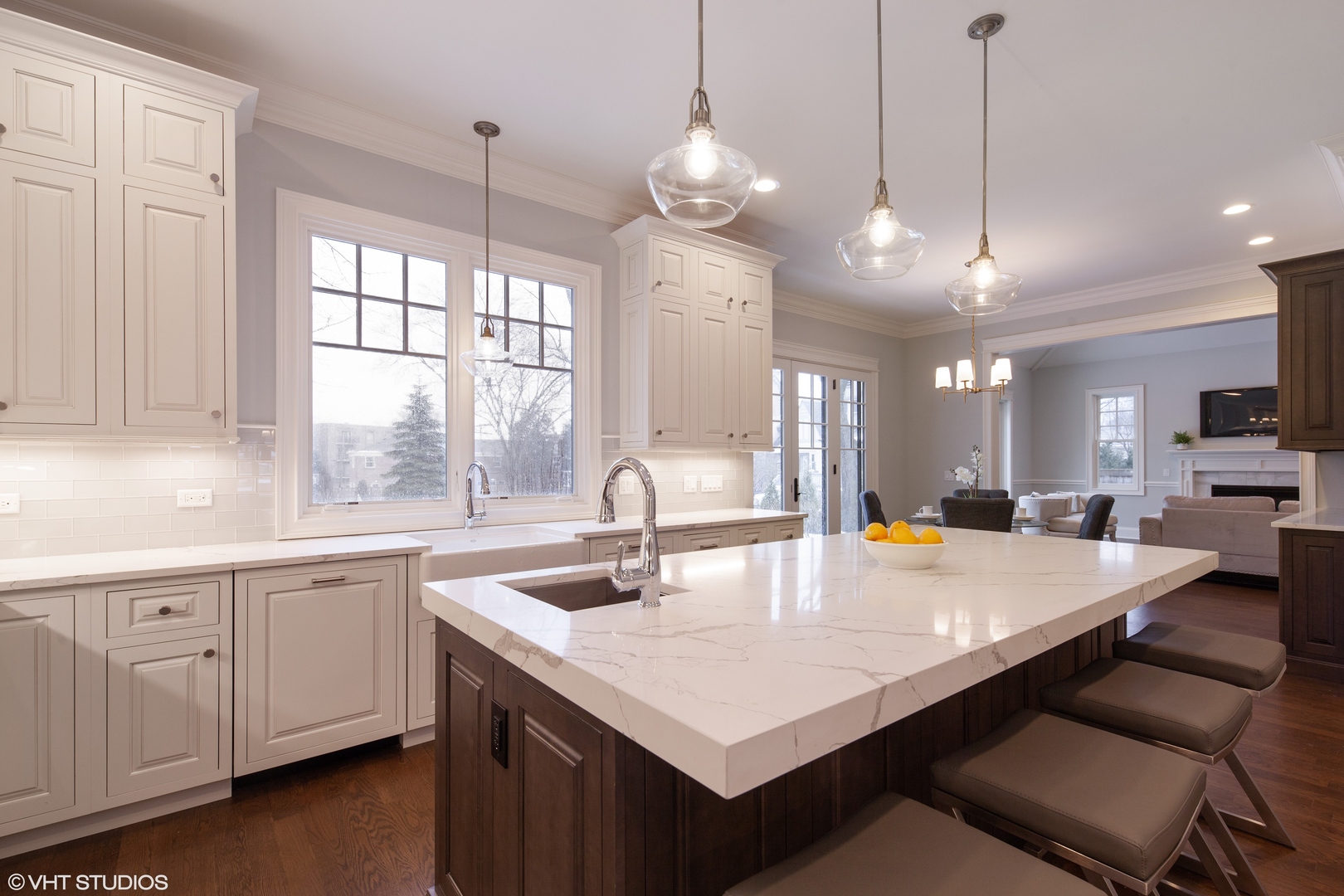 117 Church Road Winnetka, IL 60093 - Photo 8 of 29 a kitchen with center island a sink dishwasher and a large window with wooden floor