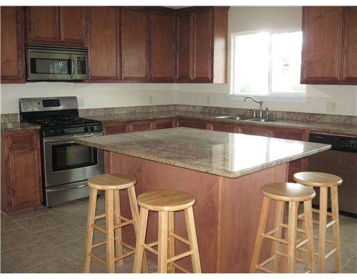3268 Ave A Ingleside, TX 78362 - Photo 3 of 7 a kitchen with a stove a sink and a microwave
