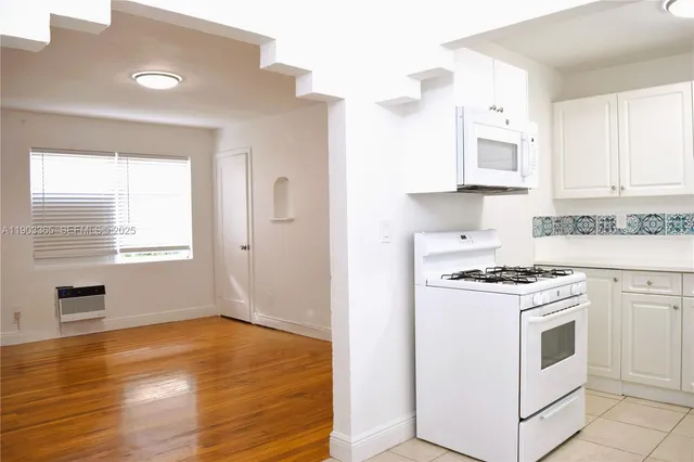 a white refrigerator freezer and a stove in a kitchen