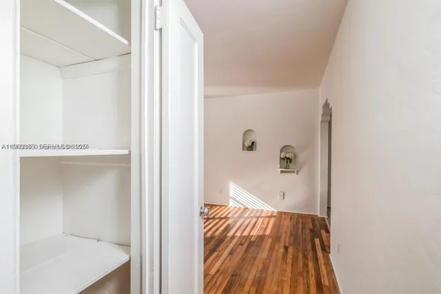a view of a small space with wooden floor