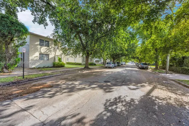 a view of backyard of house with green space