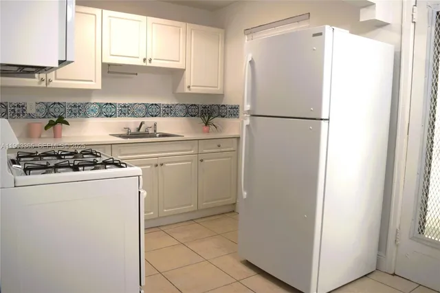 a white refrigerator freezer sitting inside of a kitchen