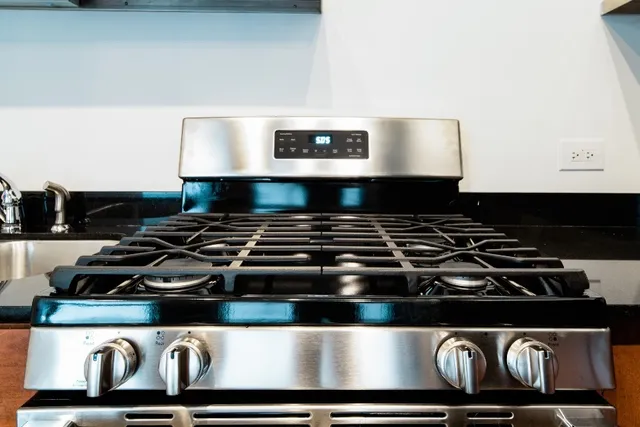 a kitchen with granite countertop a stove and a microwave
