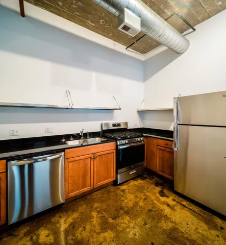 a kitchen with a refrigerator stove and cabinets