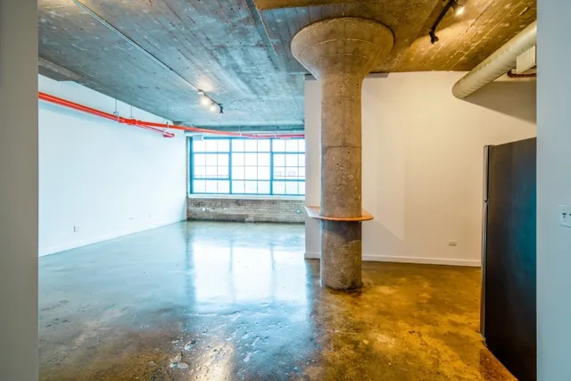 a kitchen with stainless steel appliances granite countertop a sink and a refrigerator