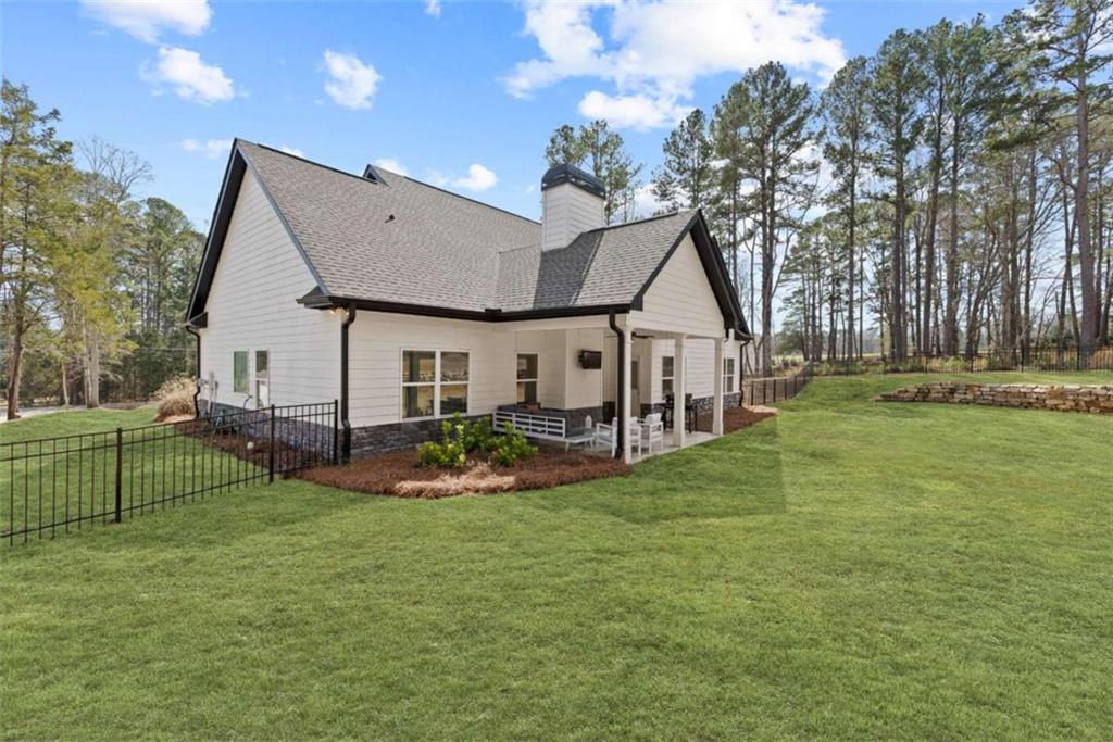 105 Capps Lane Eatonton, GA 31024 - Photo 19 of 65 a view of a house with a big yard and large trees