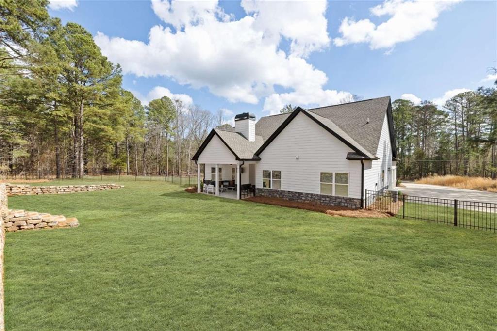105 Capps Lane Eatonton, GA 31024 - Photo 21 of 65 a view of a house with a yard and sitting area