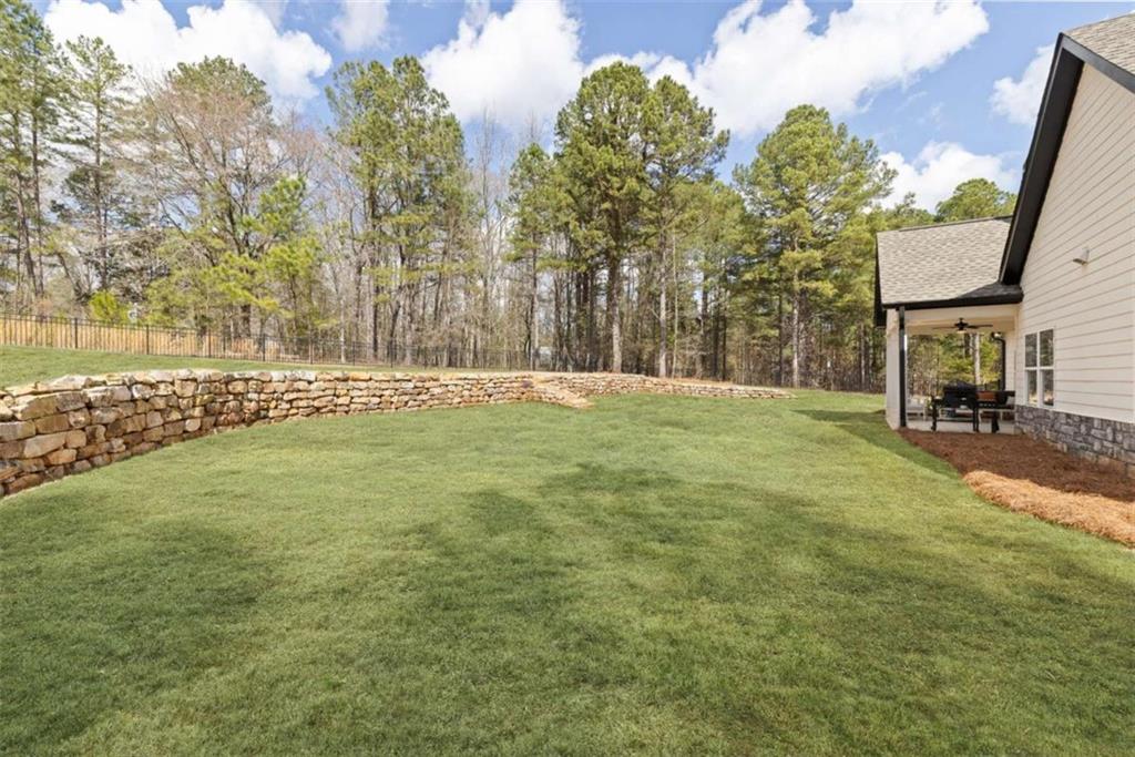 105 Capps Lane Eatonton, GA 31024 - Photo 22 of 65 a backyard of a house with table and chairs