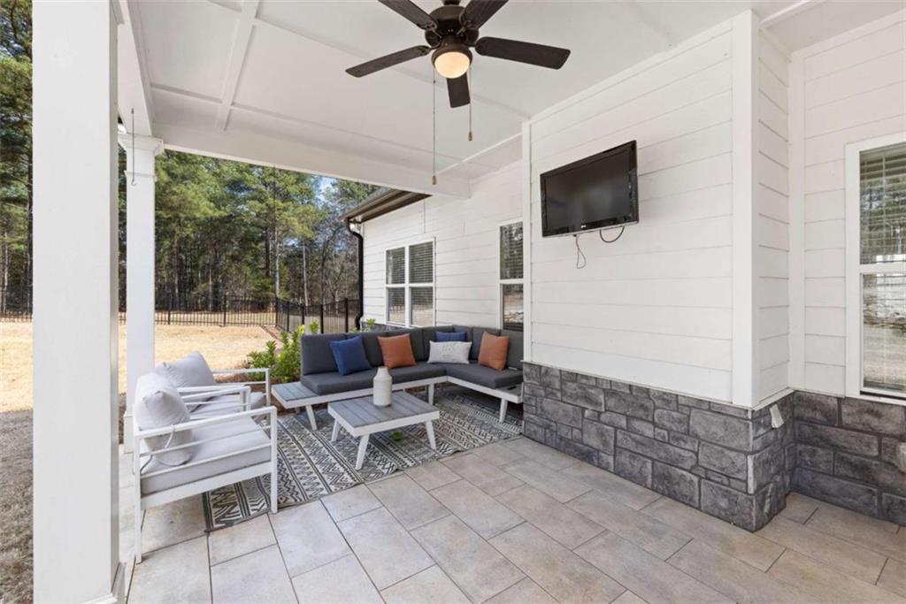 105 Capps Lane Eatonton, GA 31024 - Photo 23 of 65 a living room with furniture and a flat screen tv