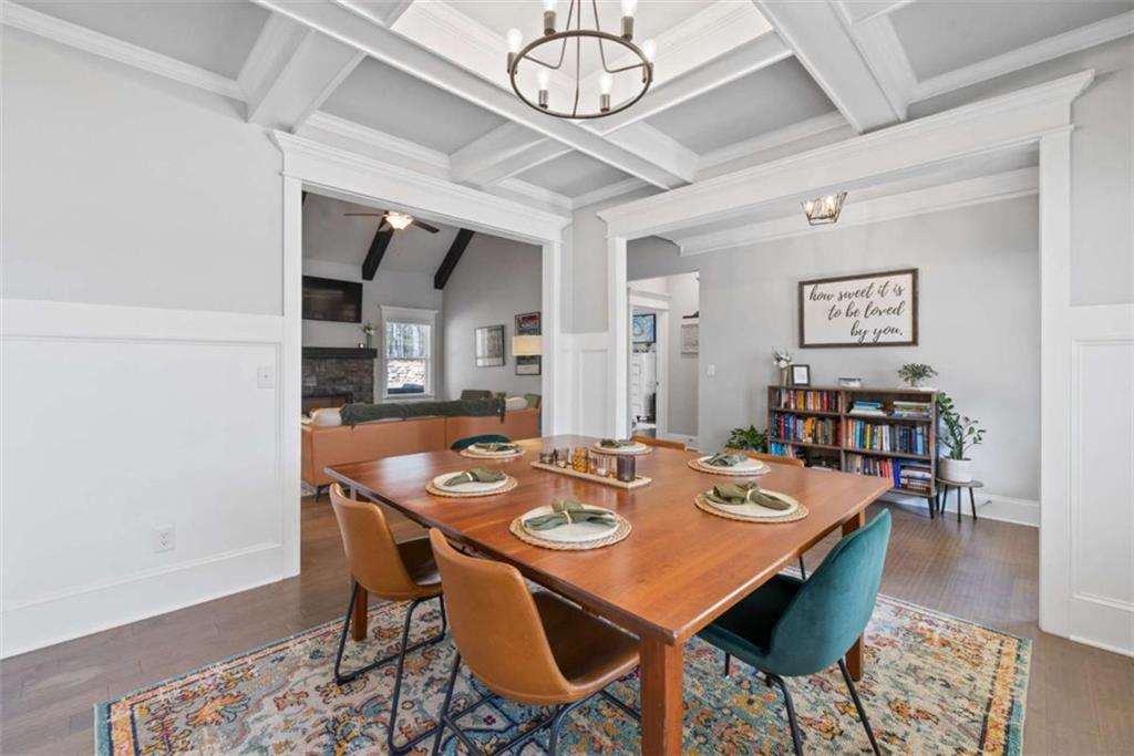 105 Capps Lane Eatonton, GA 31024 - Photo 28 of 65 a dining room with wooden floor a chandelier a wooden table and chairs