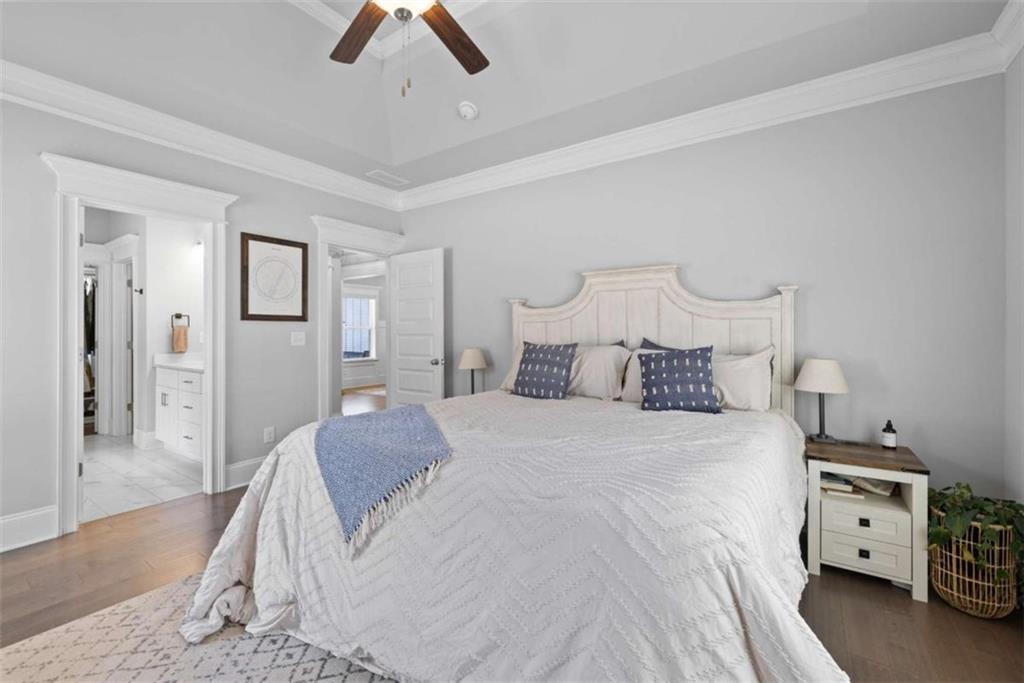 105 Capps Lane Eatonton, GA 31024 - Photo 34 of 65 a bedroom with a bed and a chandelier