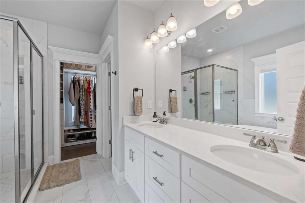 105 Capps Lane Eatonton, GA 31024 - Photo 36 of 65 a spacious en suite bathroom with a double vanity sink a large mirror and a shower