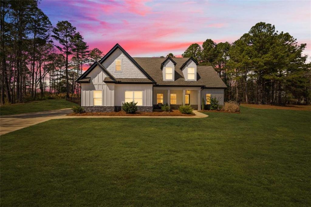 105 Capps Lane Eatonton, GA 31024 - Photo 4 of 65 a front view of a house with a garden