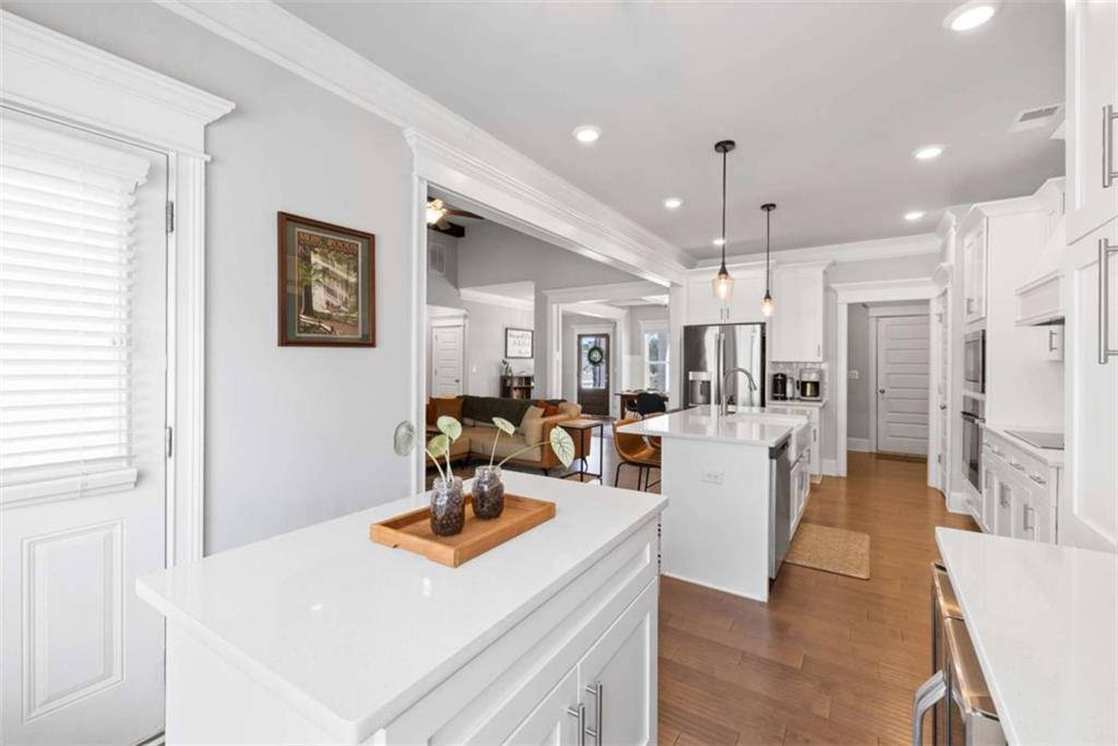 105 Capps Lane Eatonton, GA 31024 - Photo 43 of 65 a view of a kitchen with kitchen island stainless steel appliances wooden floor and living room view