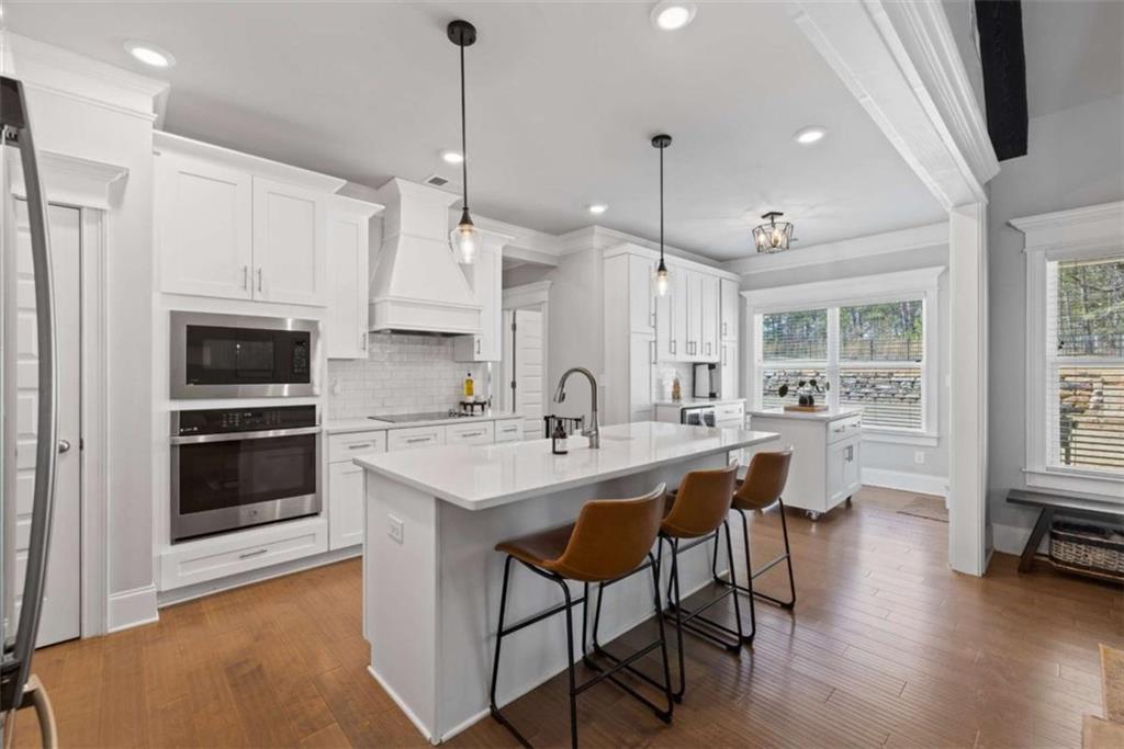 105 Capps Lane Eatonton, GA 31024 - Photo 47 of 65 a kitchen with stainless steel appliances a stove a sink a oven a kitchen island with a dining table and chairs