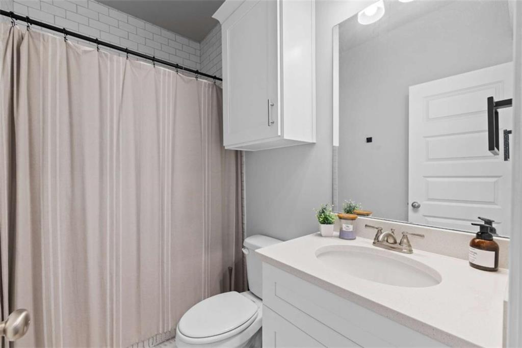105 Capps Lane Eatonton, GA 31024 - Photo 54 of 65 a bathroom with a sink a toilet and vanity