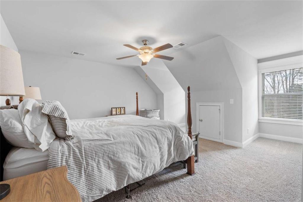 105 Capps Lane Eatonton, GA 31024 - Photo 64 of 65 a bedroom with a bed and a ceiling fan