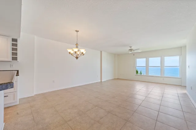 a view of a kitchen with a sink and refrigerator