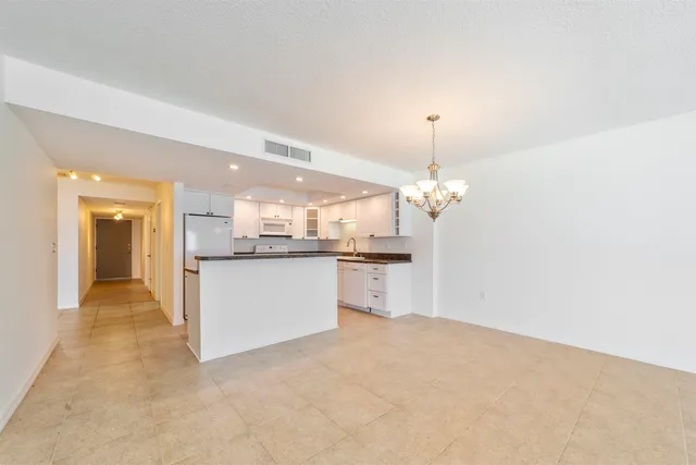 a kitchen with a refrigerator a sink and cabinets