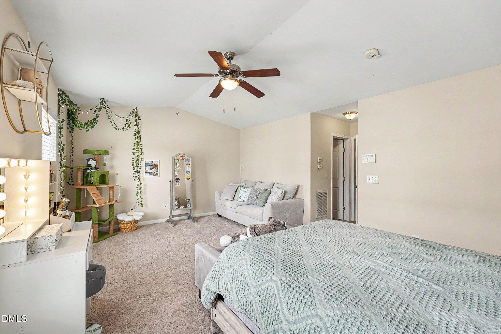 1130 Renewal Place, Unit 106 Raleigh, NC 27603 - Photo 15 of 34 a bedroom with a bed couch and window