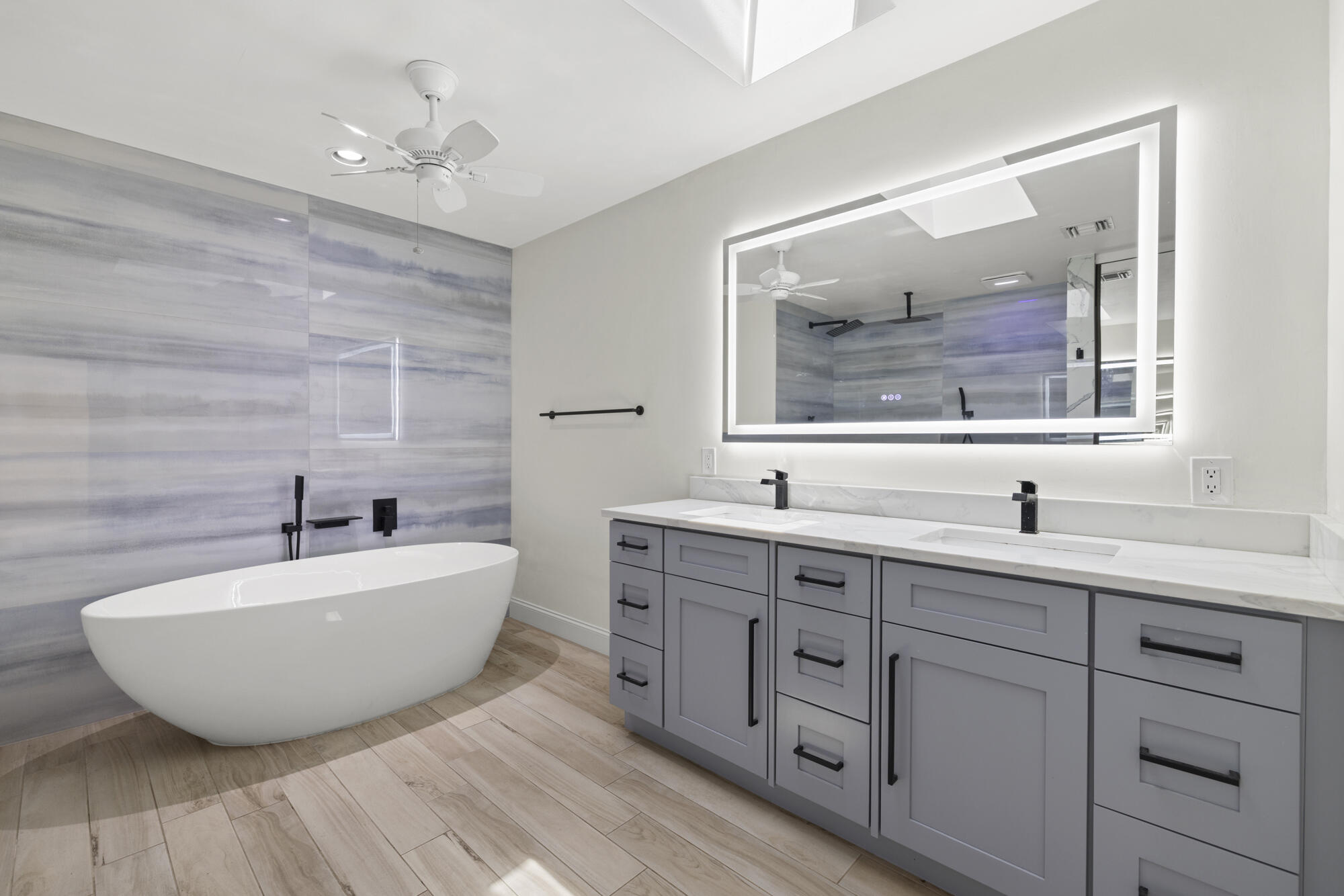 125 Cape Pointe Circle Jupiter, FL 33477 - Photo 12 of 45 a spacious bathroom with double vanity sink a bathtub and window