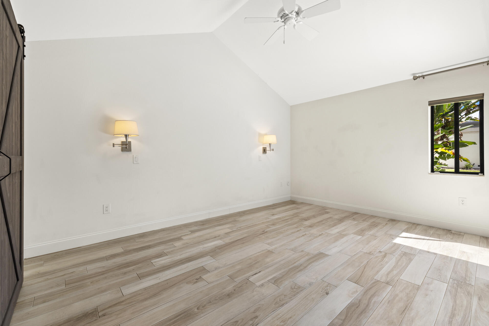 125 Cape Pointe Circle Jupiter, FL 33477 - Photo 16 of 45 an empty room with wooden floor and windows