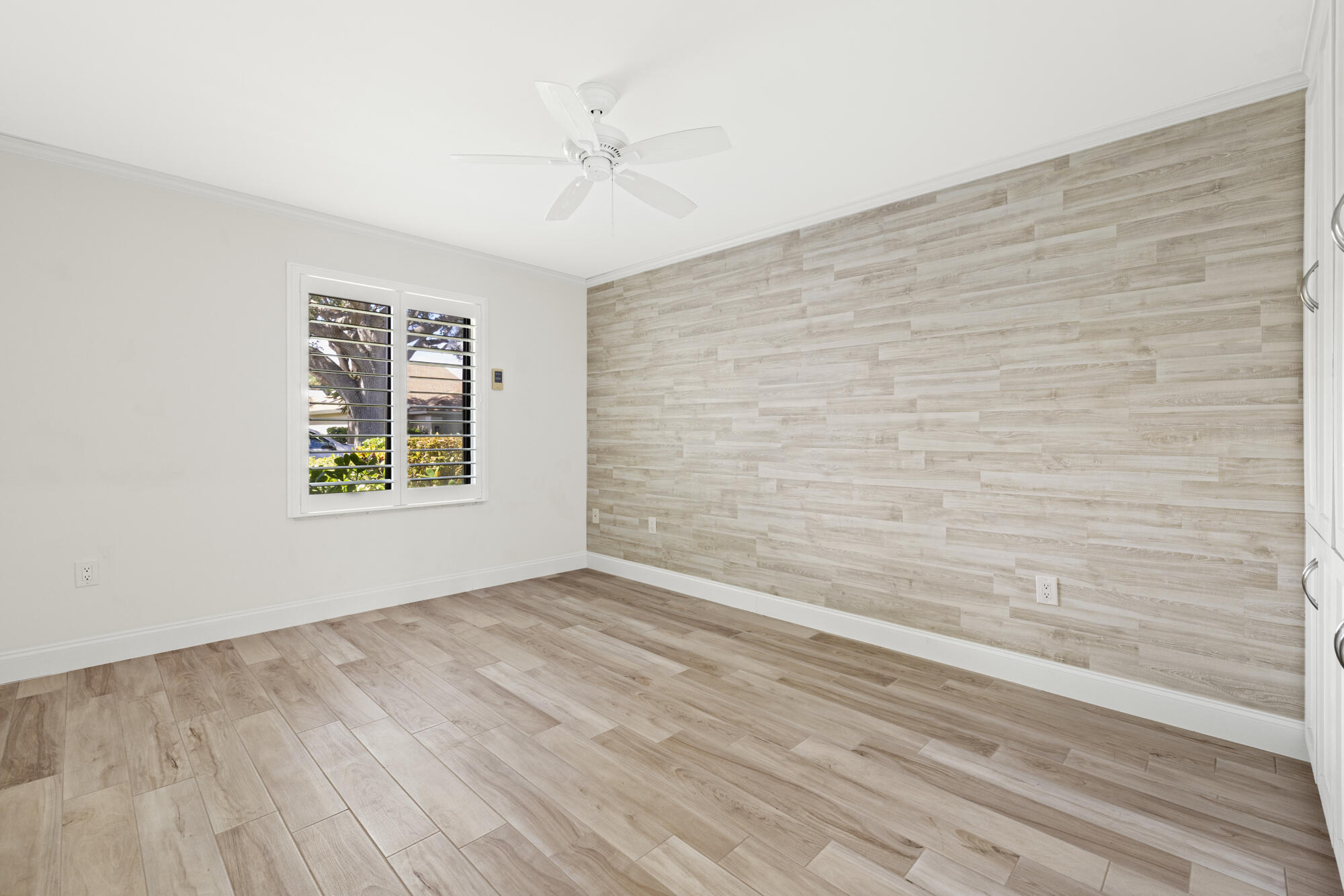 125 Cape Pointe Circle Jupiter, FL 33477 - Photo 19 of 45 a view of an empty room with a window and wooden floor