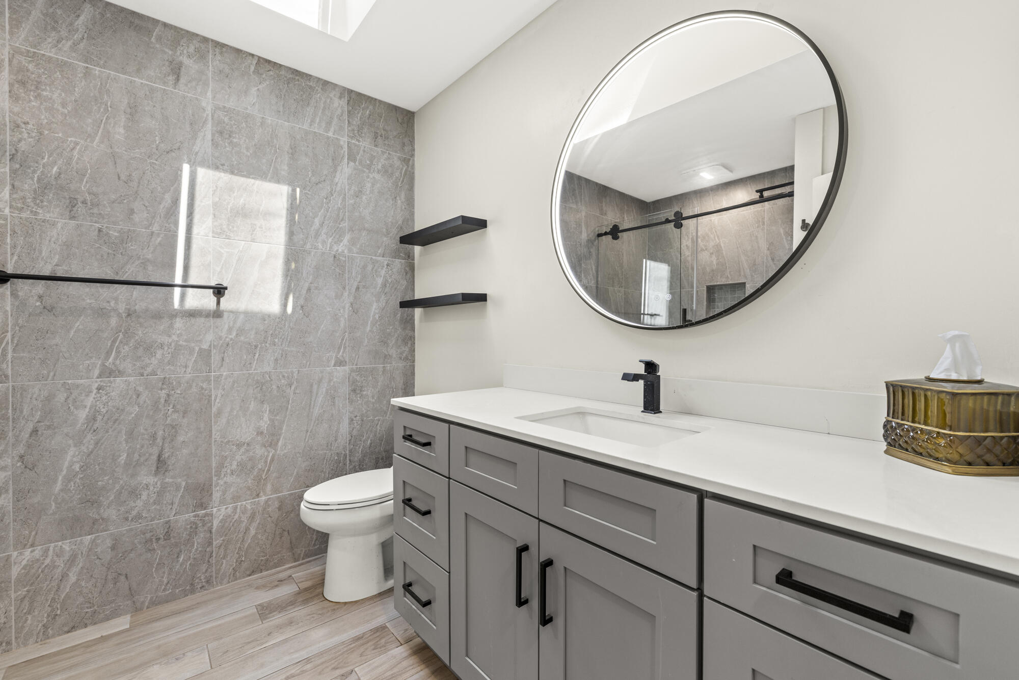 125 Cape Pointe Circle Jupiter, FL 33477 - Photo 20 of 45 a bathroom with a granite countertop sink a toilet and a mirror