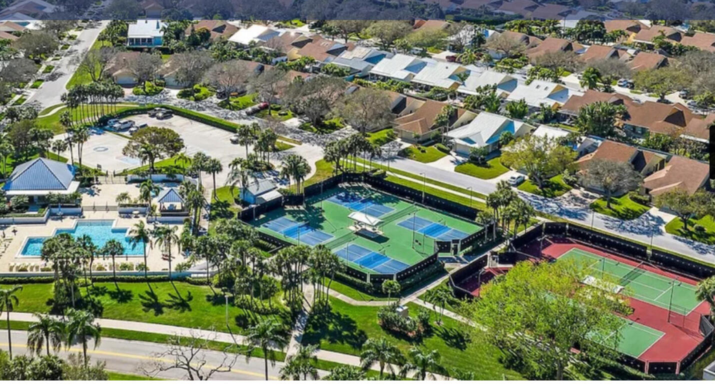 125 Cape Pointe Circle Jupiter, FL 33477 - Photo 31 of 45 an aerial view of a house with a yard and lake view