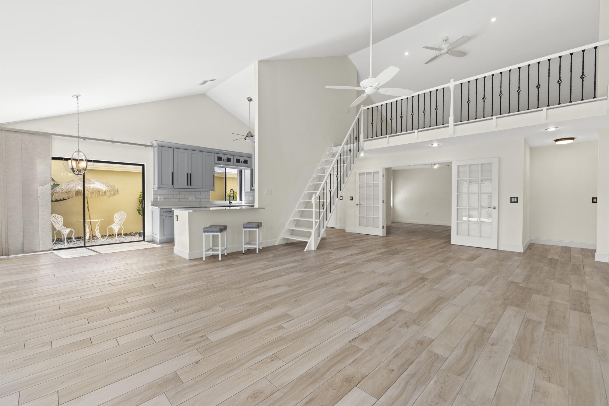 125 Cape Pointe Circle Jupiter, FL 33477 - Photo 5 of 45 a view of empty room with wooden floor and stairs