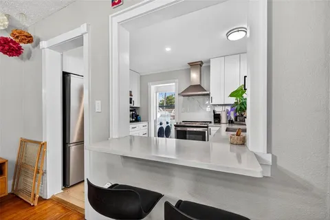 a kitchen with stainless steel appliances a microwave a stove and refrigerator