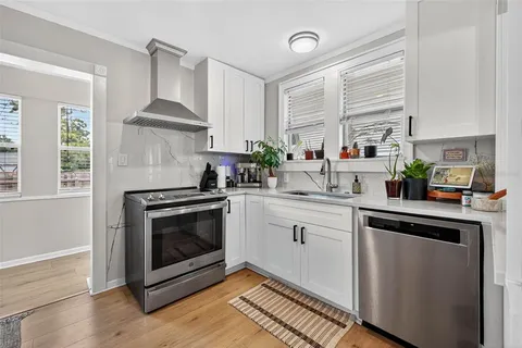 a kitchen with a stove a sink and a microwave