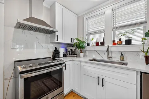 a kitchen with appliances cabinets and a window