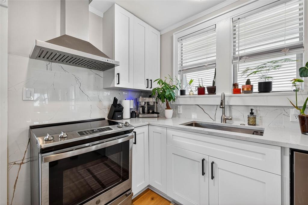 447 23rd Street North St. Petersburg, FL 33713 - Photo 14 of 28 a kitchen with appliances cabinets and a window