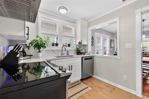 a view of a kitchen with a sink and cabinets
