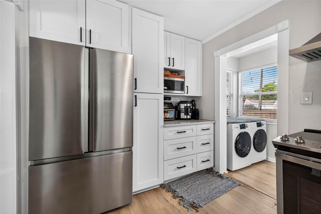 447 23rd Street North St. Petersburg, FL 33713 - Photo 16 of 28 a kitchen with stainless steel appliances a refrigerator sink and cabinets