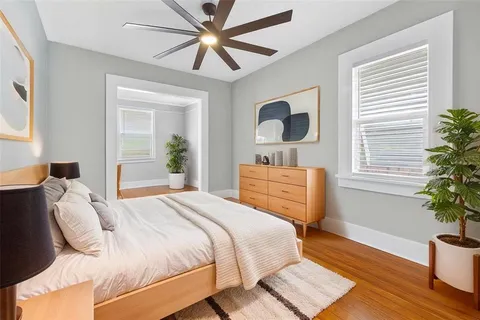 a bedroom with a bed and wooden floor
