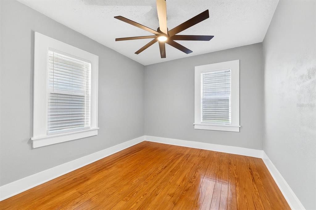 447 23rd Street North St. Petersburg, FL 33713 - Photo 20 of 28 an empty room with wooden floor windows and fan