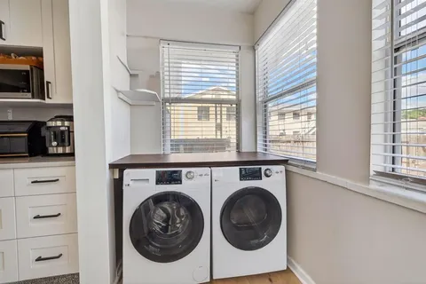 a utility room with closet dryer and washer