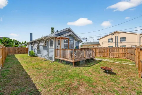 a view of a house with a yard and deck