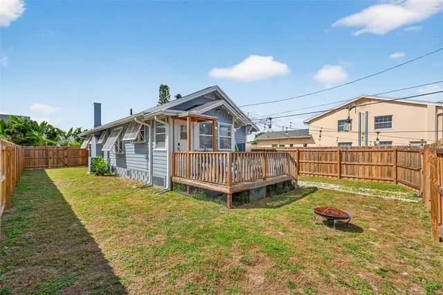 a view of a house with a yard and deck