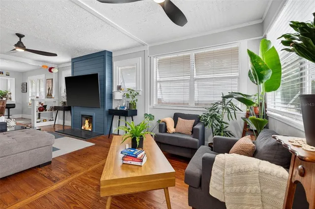 a living room with furniture a flat screen tv and a potted plant